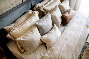 Güzellik odasında temiz beyaz yastıkları ve çarşafları olan yatak hizmetçisi. Yakın plan. Güneş ışığı altında mercek..