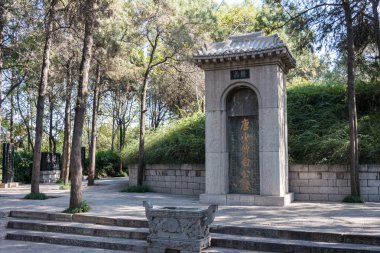 LUOYANG, CHINA - NOV 13 2014: Tomb of Bai Juyi (772-846 A.D.) in Luoyang, Henan, China. He was a famous Chinese poet of the Tang Dynasty. clipart