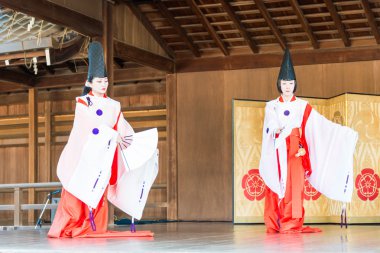 KYOTO, JAPAN - Jan 12 2015: Tradition folk Dance at a Yasaka-jinja Shrine. a famous shrine in the Ancient city of Kyoto, Japan. clipart