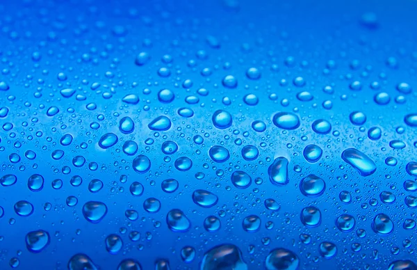 Water drops on round blue background — Stock Photo, Image