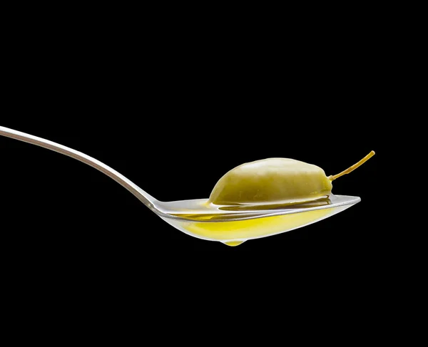 Green olive in full oil spoon isolated — Stock Photo, Image