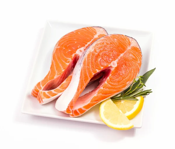Two slices of salmon steak with herbs — Stock Photo, Image