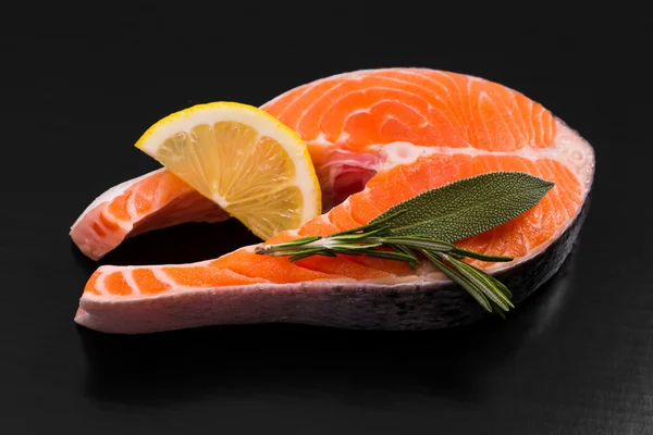 Slice of salmon steak with lemon and herbs — Stock Photo, Image