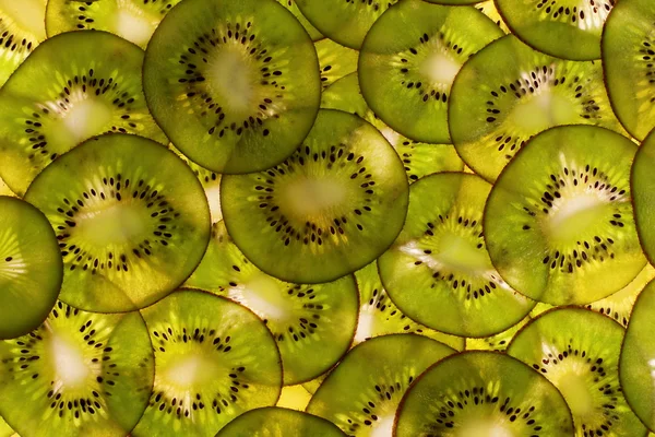 Fruto kiwi rebanado como fondo —  Fotos de Stock