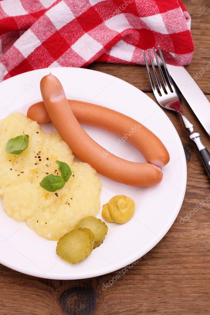 Pair of sausage with mashed potatoes, mustard
