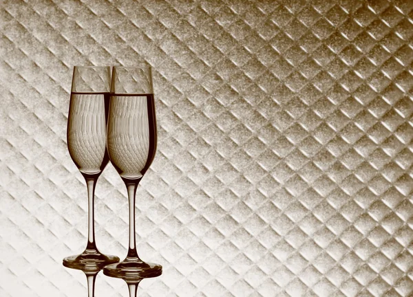 Copos de champanhe no fundo xadrez borrado — Fotografia de Stock