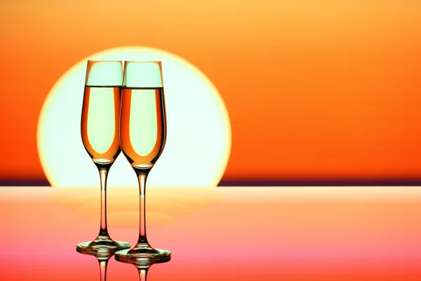 Two champagne glasses at sunset — Stock Photo, Image