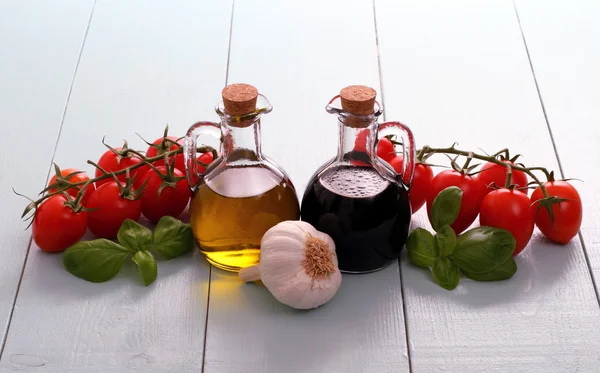 Olive oil and vinegar in bottles on wooden table — Stock Photo, Image