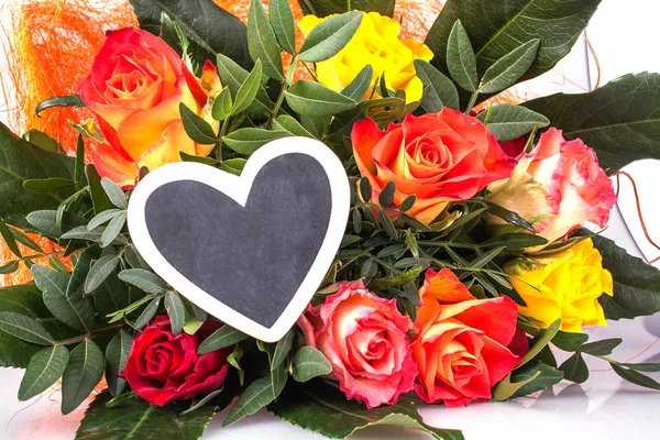 Roses with writing board in heart shape — Stock Photo, Image