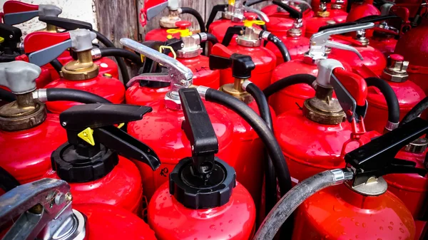 Many used fire extinguishers, top view — Stockfoto