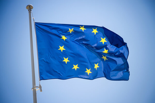 European Union flag on blue sky background