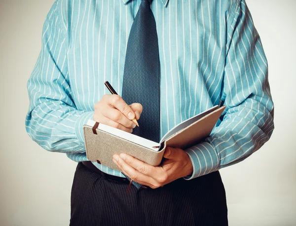 Üzletember, a notebook és a toll írás — Stock Fotó