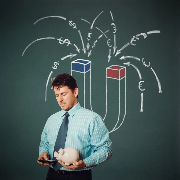 Businessman with calculator, piggy bank and money magnet on back — Stock Photo, Image