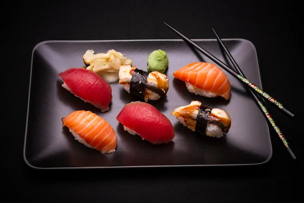 Eel, salmon and tuna sushi with chopsticks — Stock Photo, Image