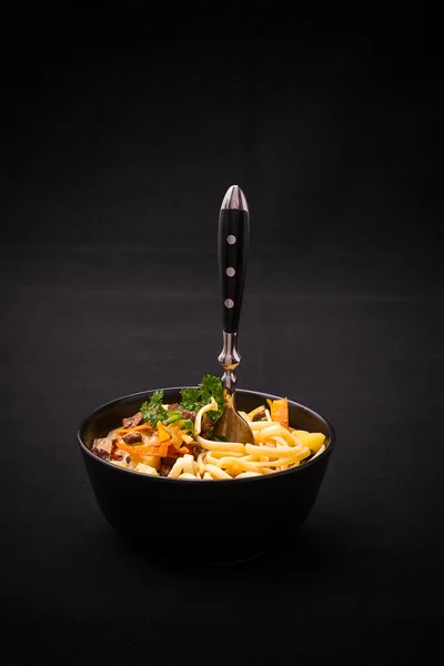 Uzbek noodle soup Lagman on black — Stock Image Uzbek noodle soup Lagman on black Royalty Free Stock Photos