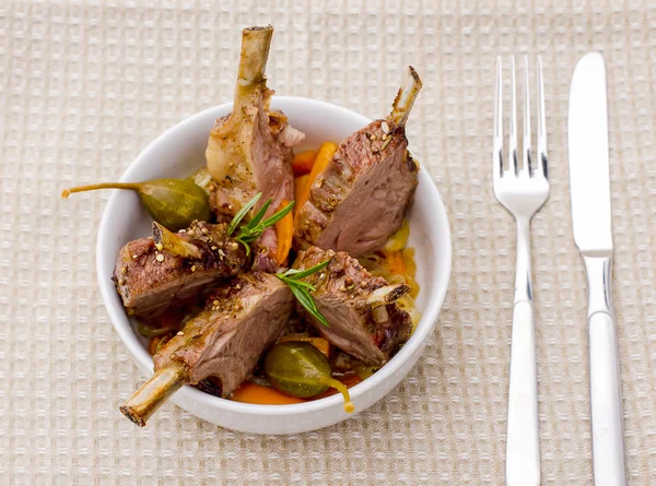 Rack of lamb with carrot onion and capers — Stock Photo, Image