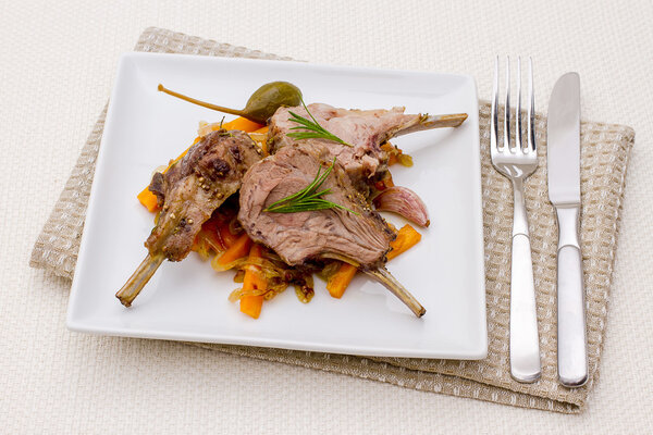 Grilled racks of lamb with carrot, onion, capers