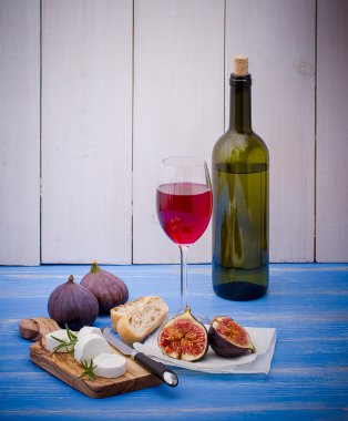 Feta cheese with ripe figs and wine clipart