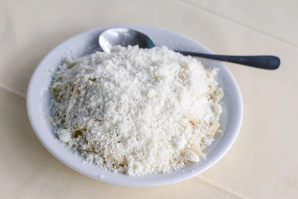 Cooked pasta with grated feta cheese — Stock Photo, Image