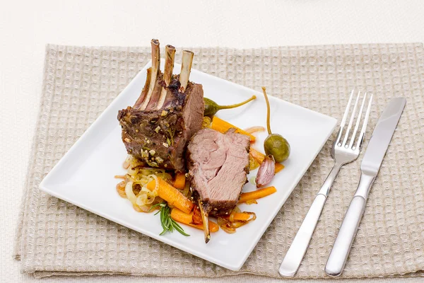 Grilled rack of lamb with carrot onion Stock Picture