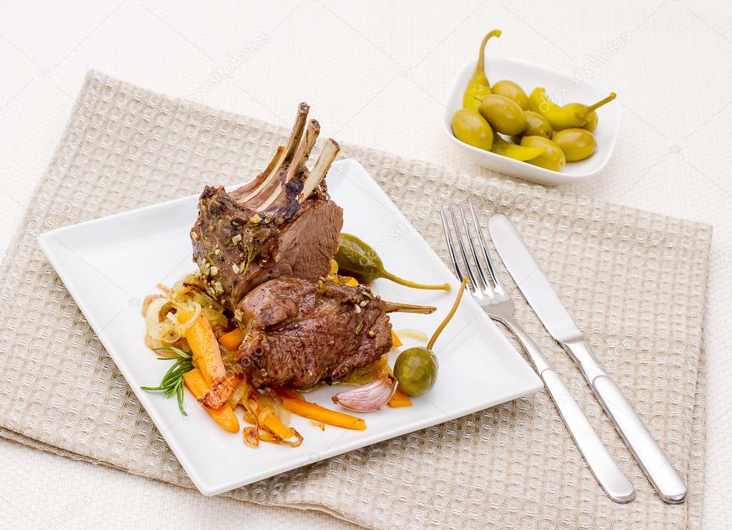 Grilled rack of lamb with carrot onion, garlic