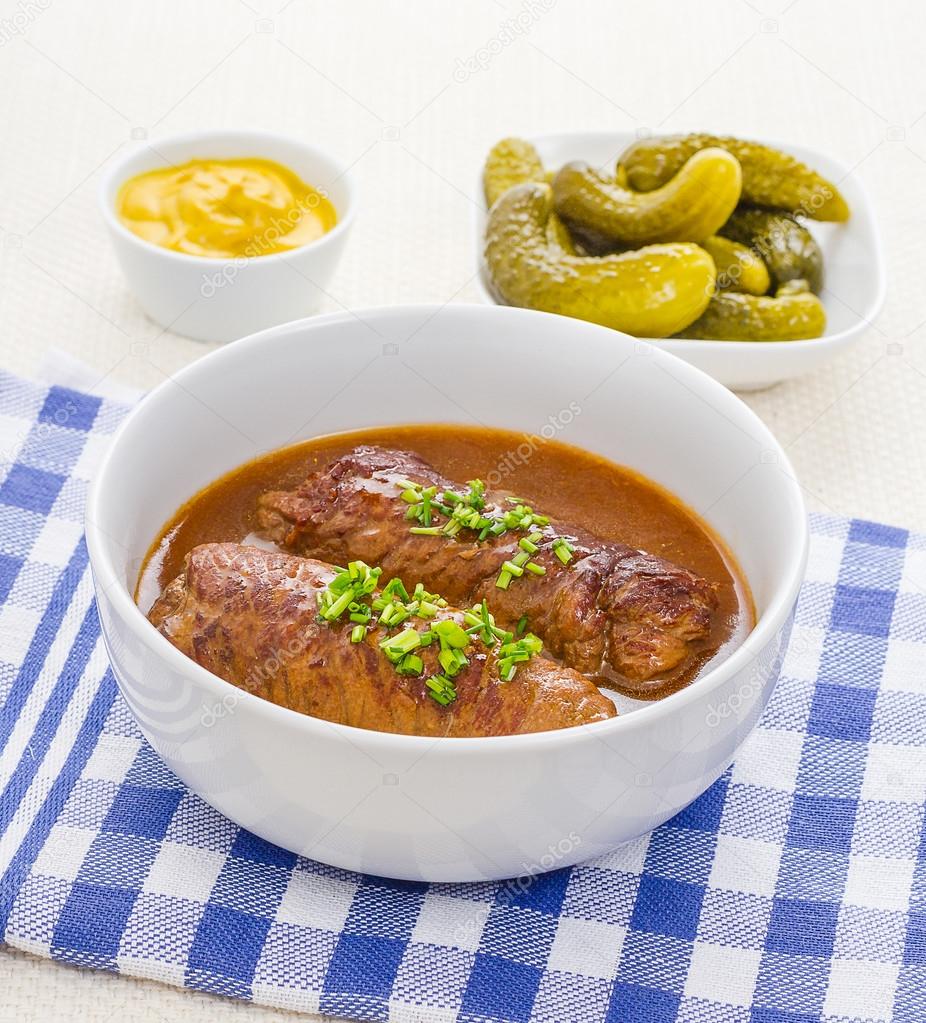Two roulades beef in bowl with sauce