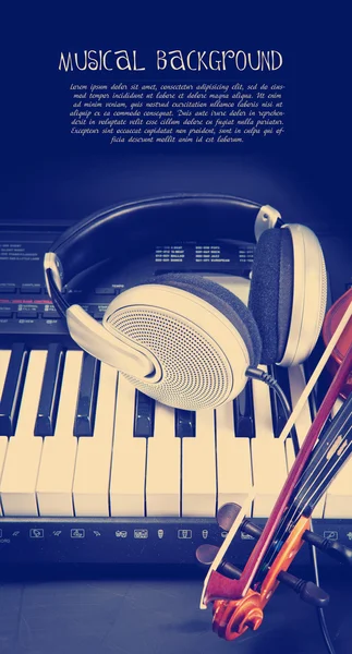 Violin, piano keys and headphones — Stock Photo, Image