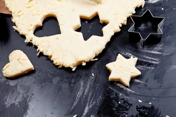 Cheese pastry dough with cookie cutters and shapes — Stock Photo, Image