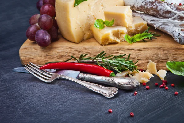 Various cheeses and salami — Stock Photo, Image