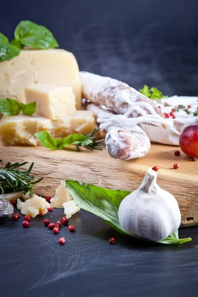 Various cheeses and salami — Stock Photo, Image