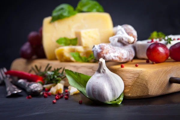 Various cheeses and salami — Stock Photo, Image