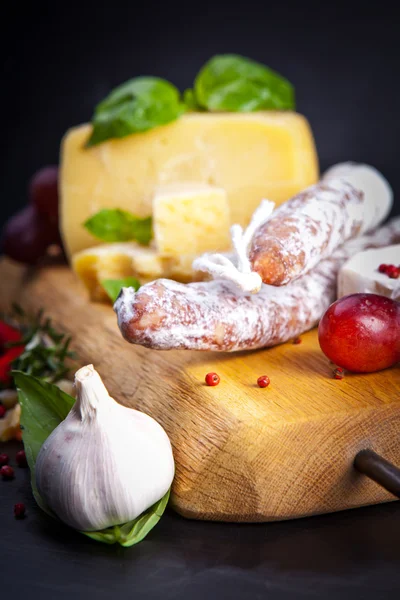 Various cheeses and salami — Stock Photo, Image
