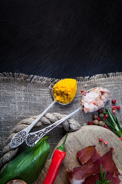 Herbs and spices in spoons — Stock Photo, Image