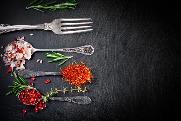 Herbs and spices in spoons — Stock Photo, Image