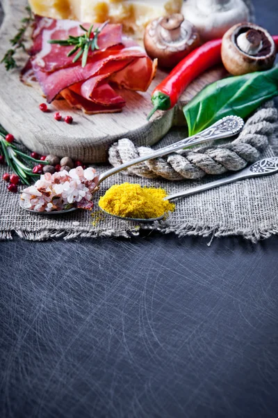 Herbs and spices in spoons — Stock Photo, Image