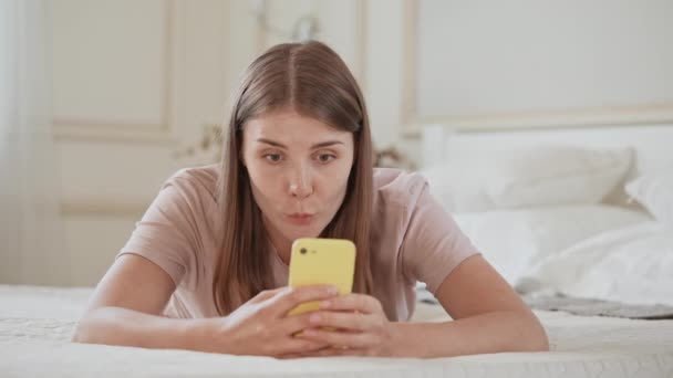 Female messaging use mobile in apartment — Stock video