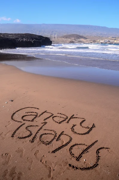 Slovo napsané na písku — Stock fotografie