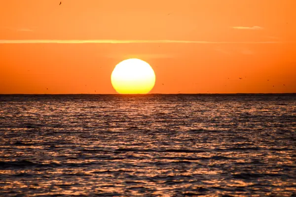 Il sole che tramonta nel mare — Foto Stock