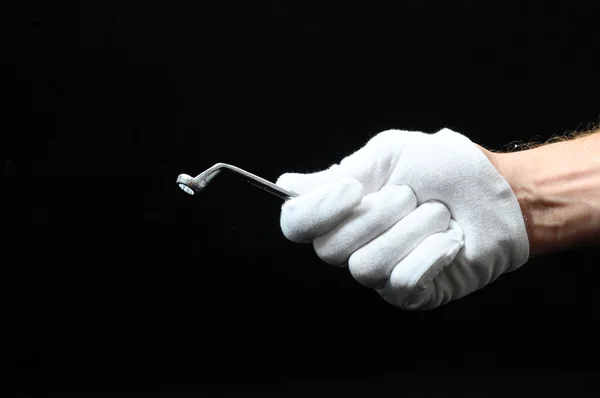 Eine Schlüsselschraube und eine Hand — Stockfoto
