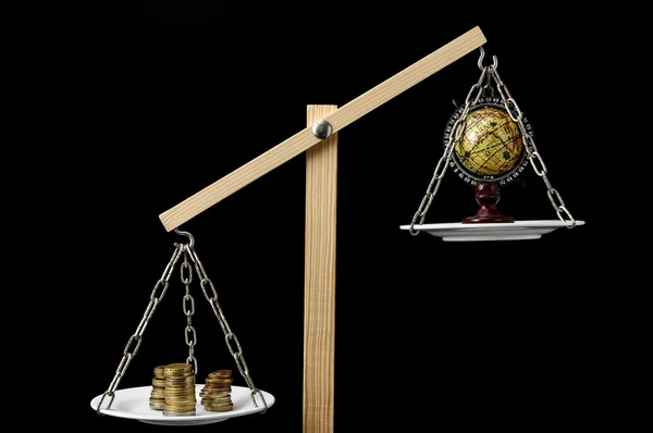 Earth and Money on a Two Pan Balance — Stock Photo, Image