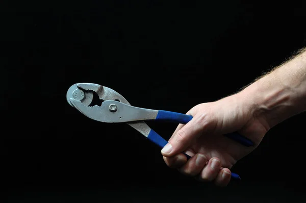 Pliers and a Hand — Stock Photo, Image