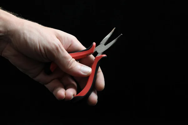 Pliers and a Hand — Stock Photo, Image