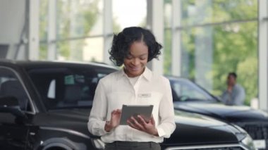 Oto kuaförde tablet kullanan Afrikalı Amerikalı kadın.