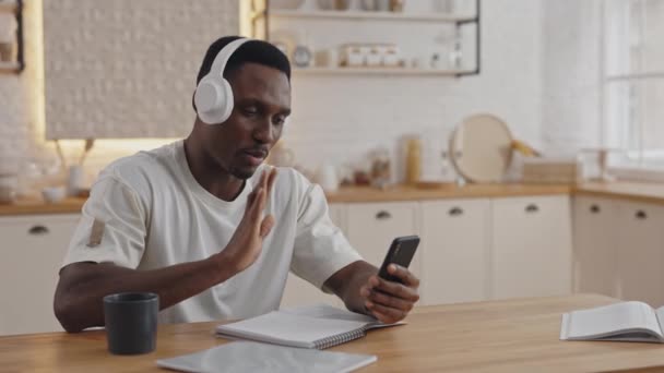 African student talking during video call on smartphone — Αρχείο Βίντεο