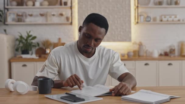 African man spending free time at home for self education — Stock video