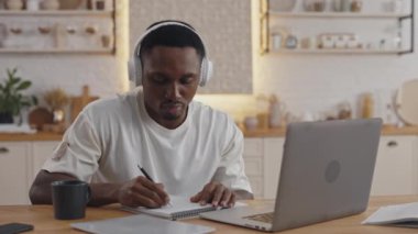 Afrikalı öğrenci evde çalışmak için dizüstü bilgisayar kullanıyor