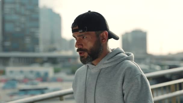 Tired bearded runner drinking water outdoors — Video Stock