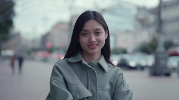 Sorridente donna asiatica in piedi da solo sulla strada della città — Video Stock