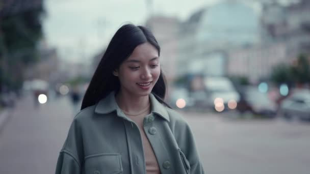 Mujer china feliz caminando al aire libre y usando el teléfono celular — Vídeos de Stock