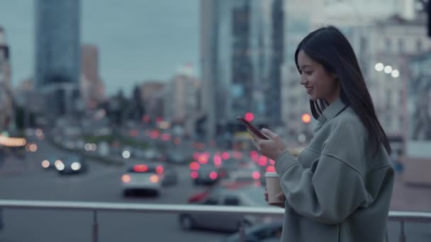 Asiatico donna sorridente sinceramente mentre utilizzando mobile su strada — Video Stock